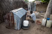 A man tending to his poultry