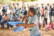 A woman demonstrating the use of toilet.