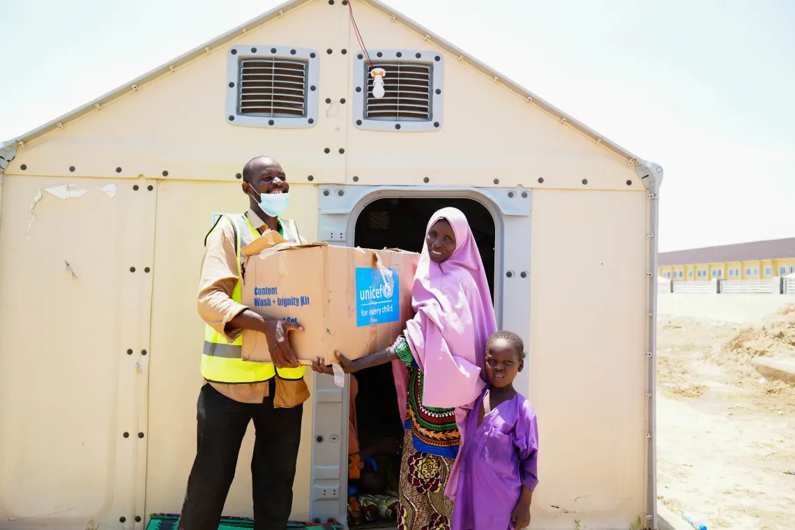 A woman receiving a hygiene kit