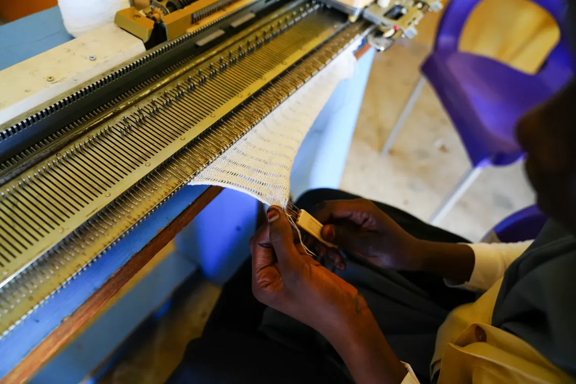 A girl operating a sewing machine