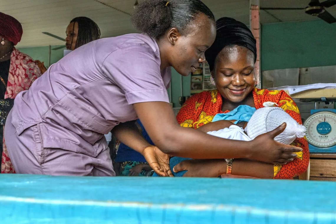 Healthworker showing a mother how to breastfeed