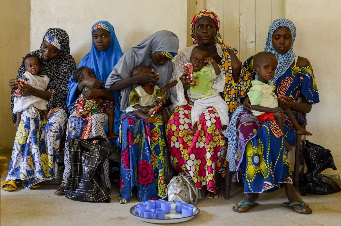 Mothers feed their children with therapeutic food at a malnutrition treatment centre in northern Nigeria