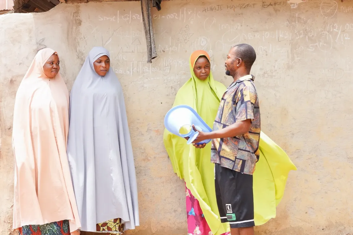 A man speaking with community members