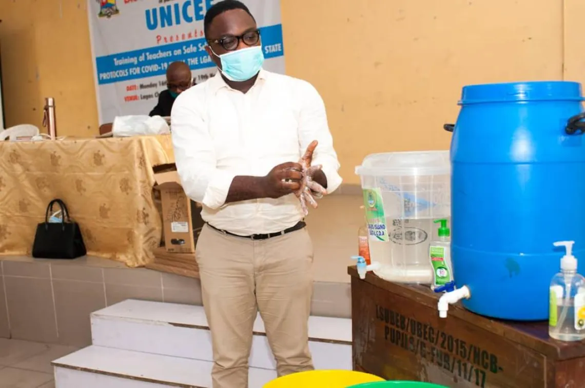 A teacher demonstrates proper handwashing