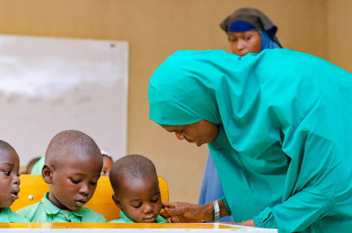 Azumi watches as health workers administer vaccines to pupils in her class in Azare 