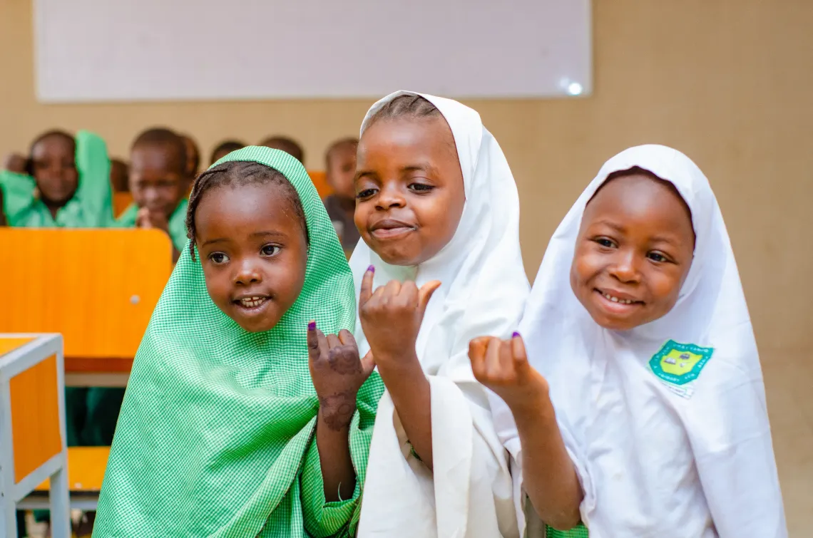 Vaccinated girls showing their marked fingers