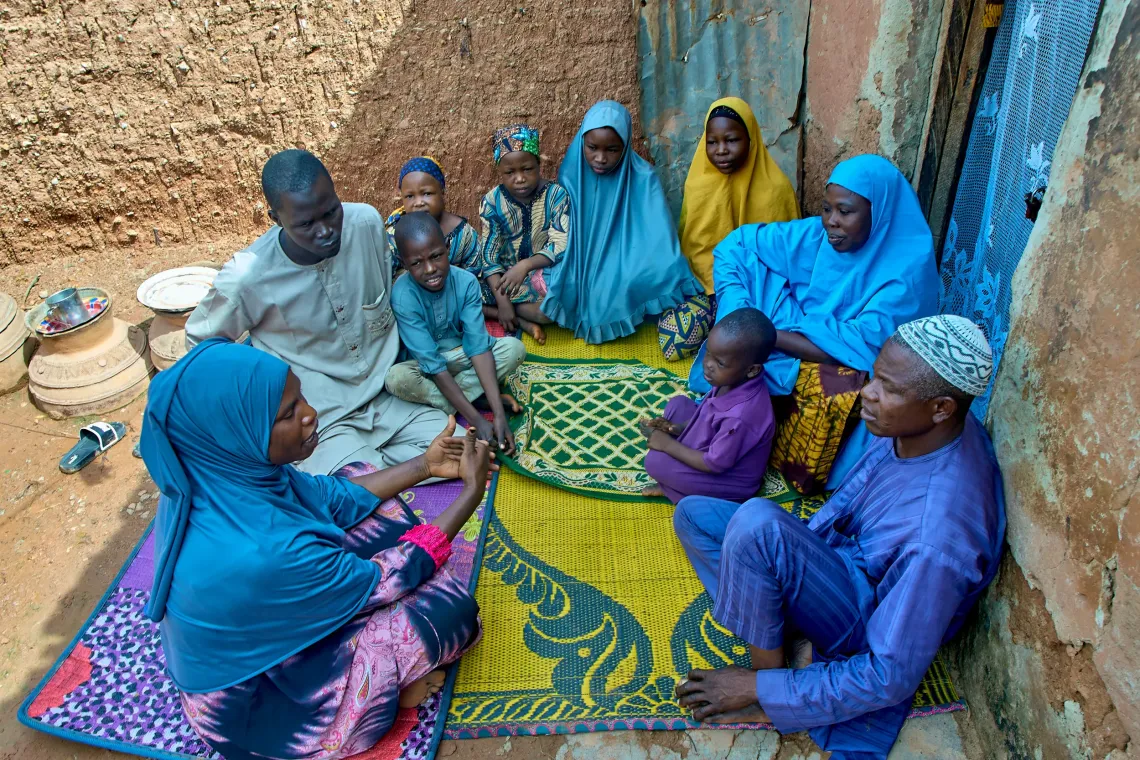 A family conversing in their home.