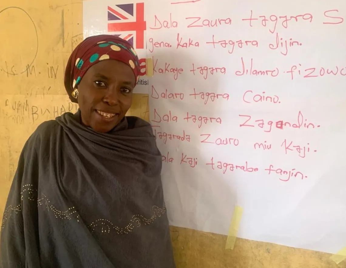A woman standing beside a board