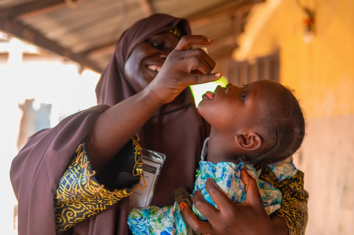 A vaccinator vaccinating a child
