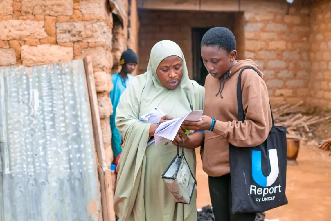 A young person sensitizing a woman on cholera prevention