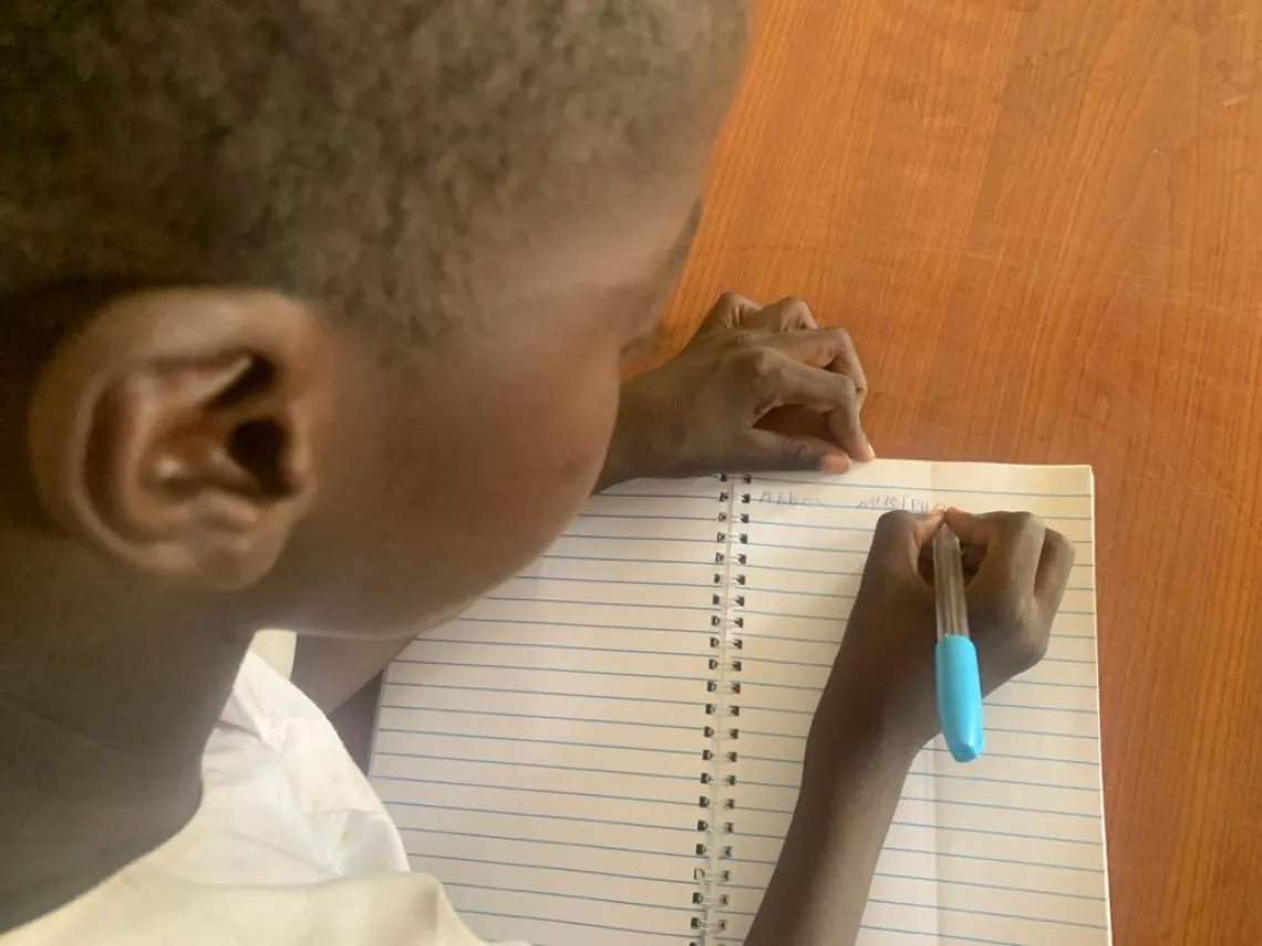 A schoolboy writing