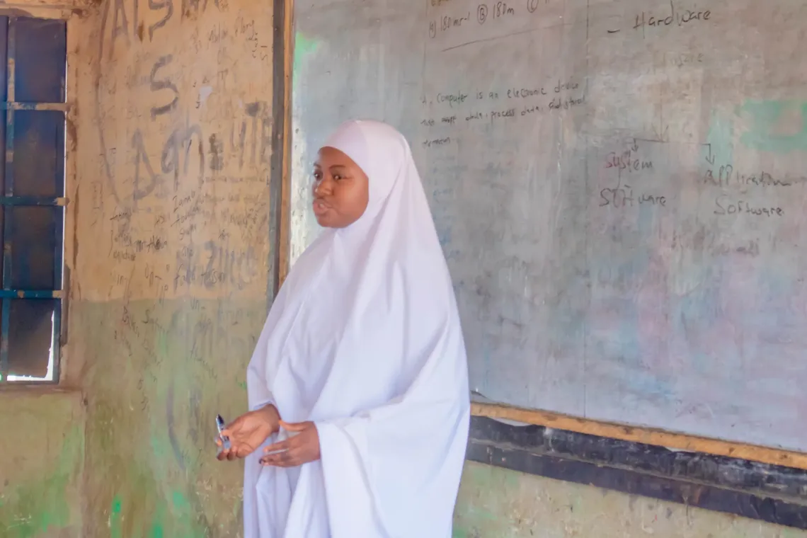 A girl in front of a classroom 