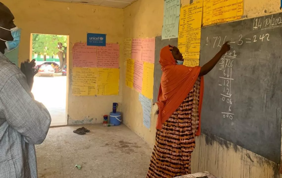 A woman writing on the blackboard