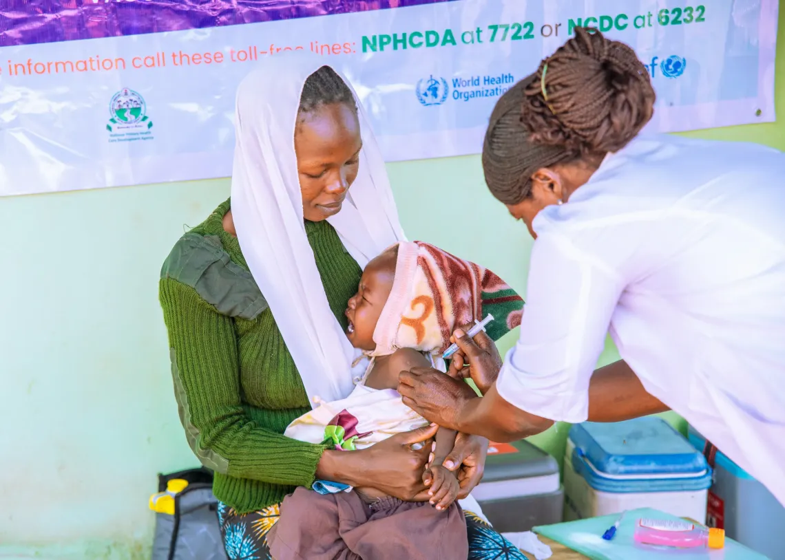 A mother and her baby getting vaccinated