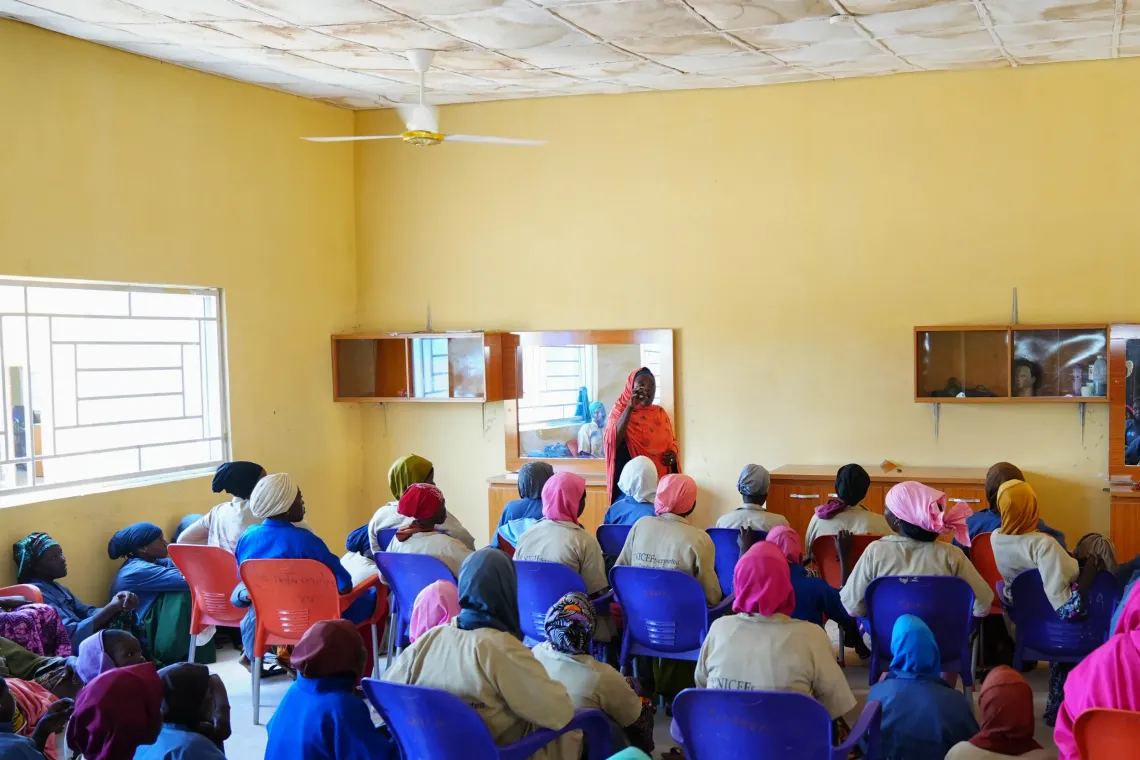  A teacher addresses girls in a classroom