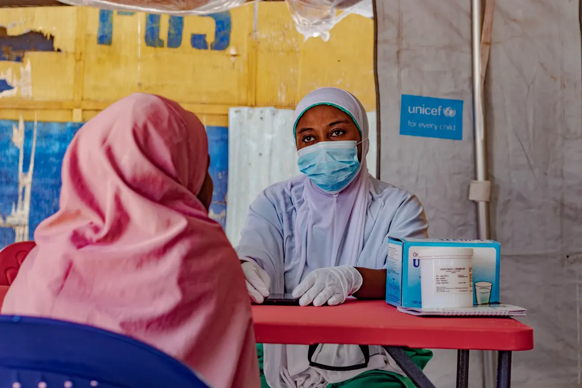 A health care worker attends to a community member