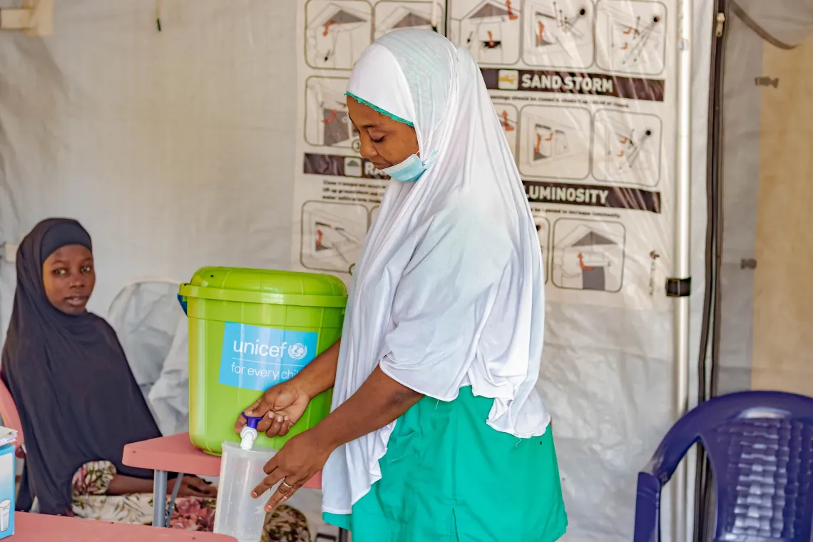 A health care worker attends to a community member