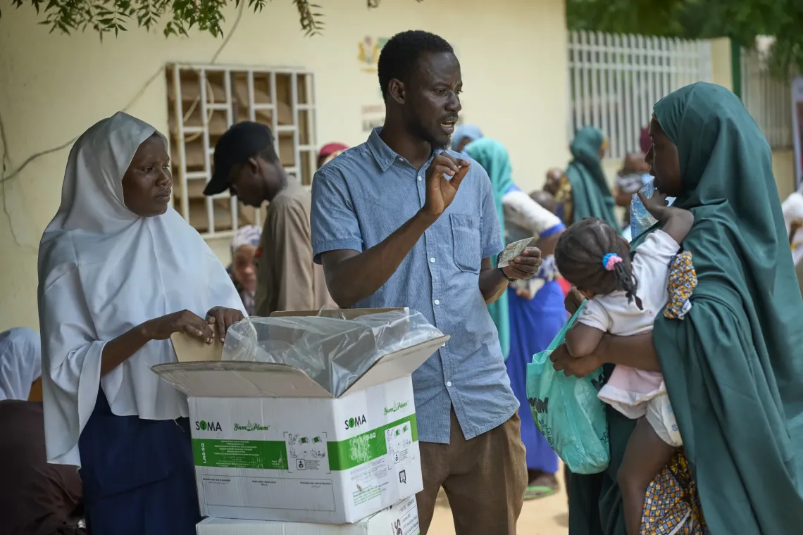 A health worker distributing SQ-LNS