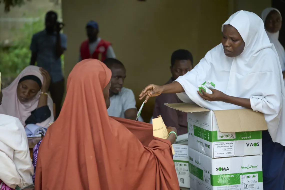 A health care worker distributes SQ-LNS