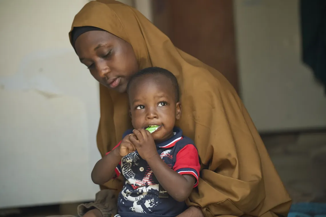 A mother feeding her son SQ-LNS