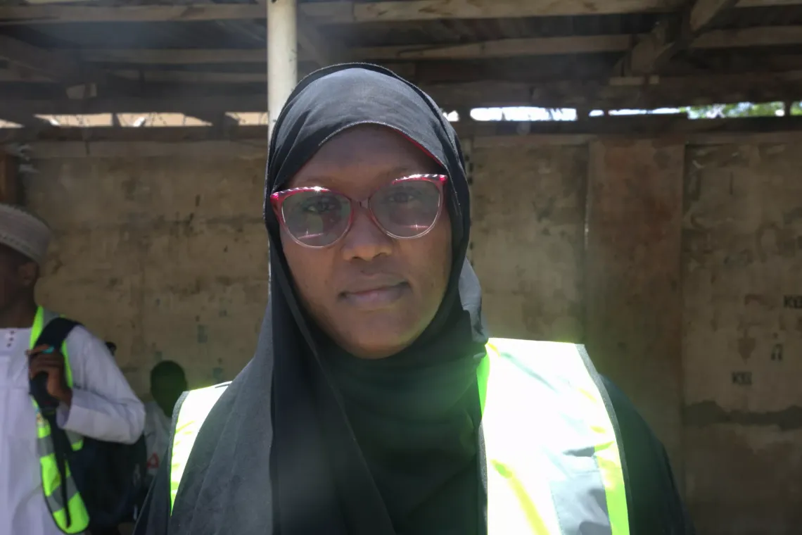 A woman standing in front of camera. 