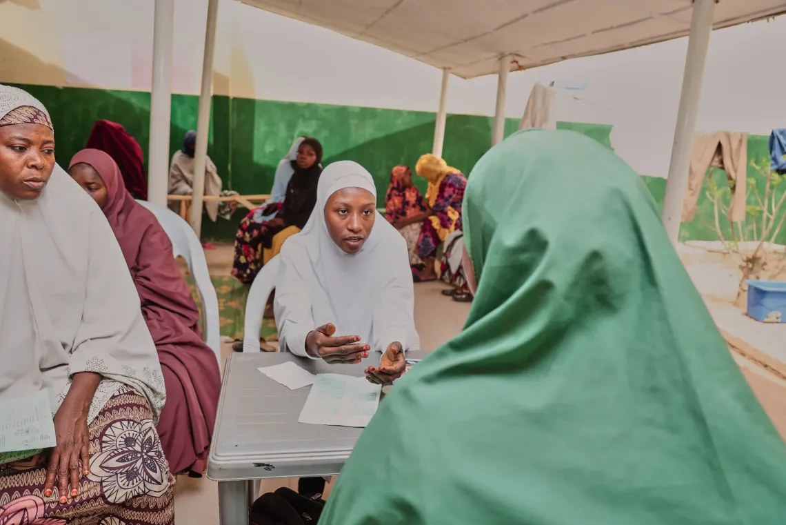 A community midwife giving health talks