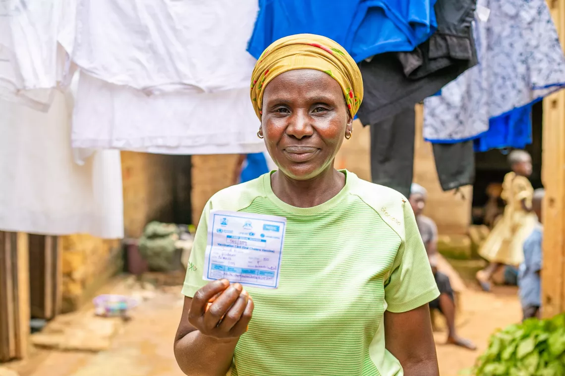 A woman holding her vaccine card
