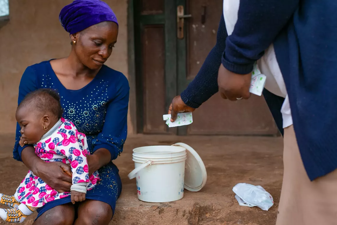 A woman and her baby with a health worker
