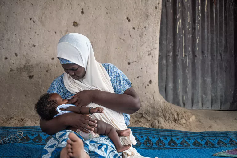 A woman breastfeeding her baby