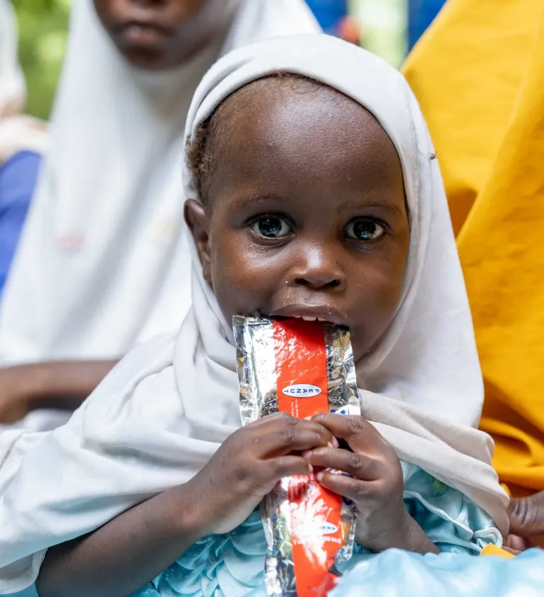 A baby eating RUTF