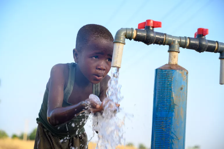 A boy at the tap
