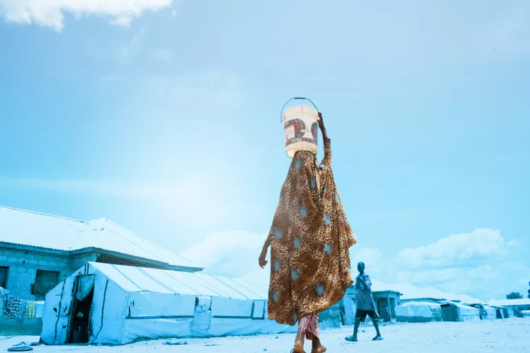 A girl carrying water 
