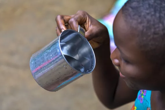 A girl drinking water from a cup
