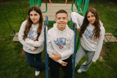 Adolescent boys and girls smiling at camera