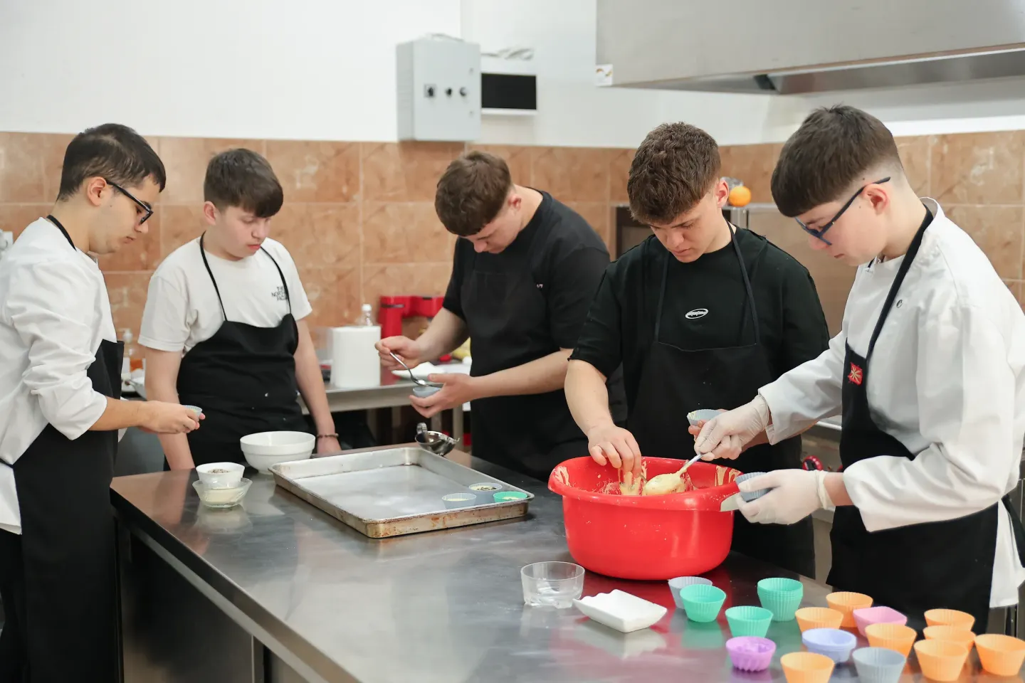 Adolescent boys preparing food in their school's kitchen 