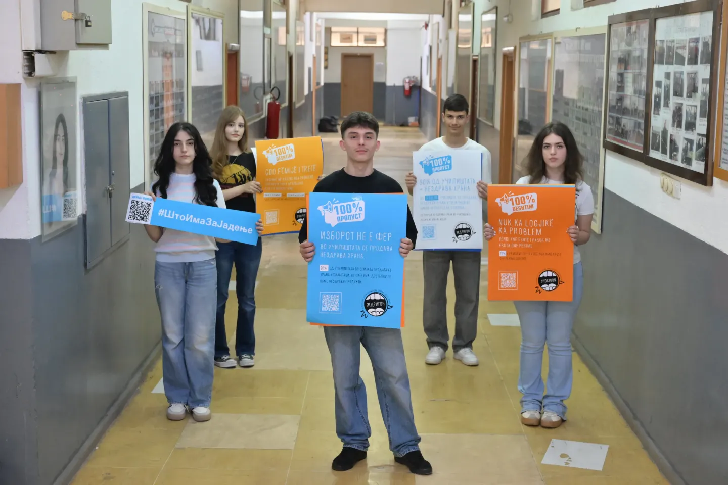 Group of adolescents holding posters with data and messages on food environments in their school