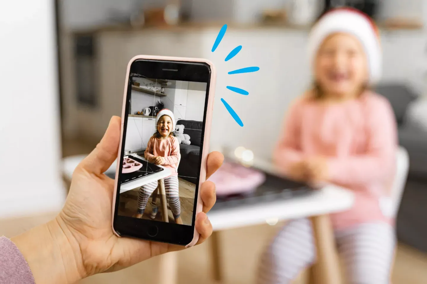 Parent or a caregiver taking a photo of a child with a smartphone 