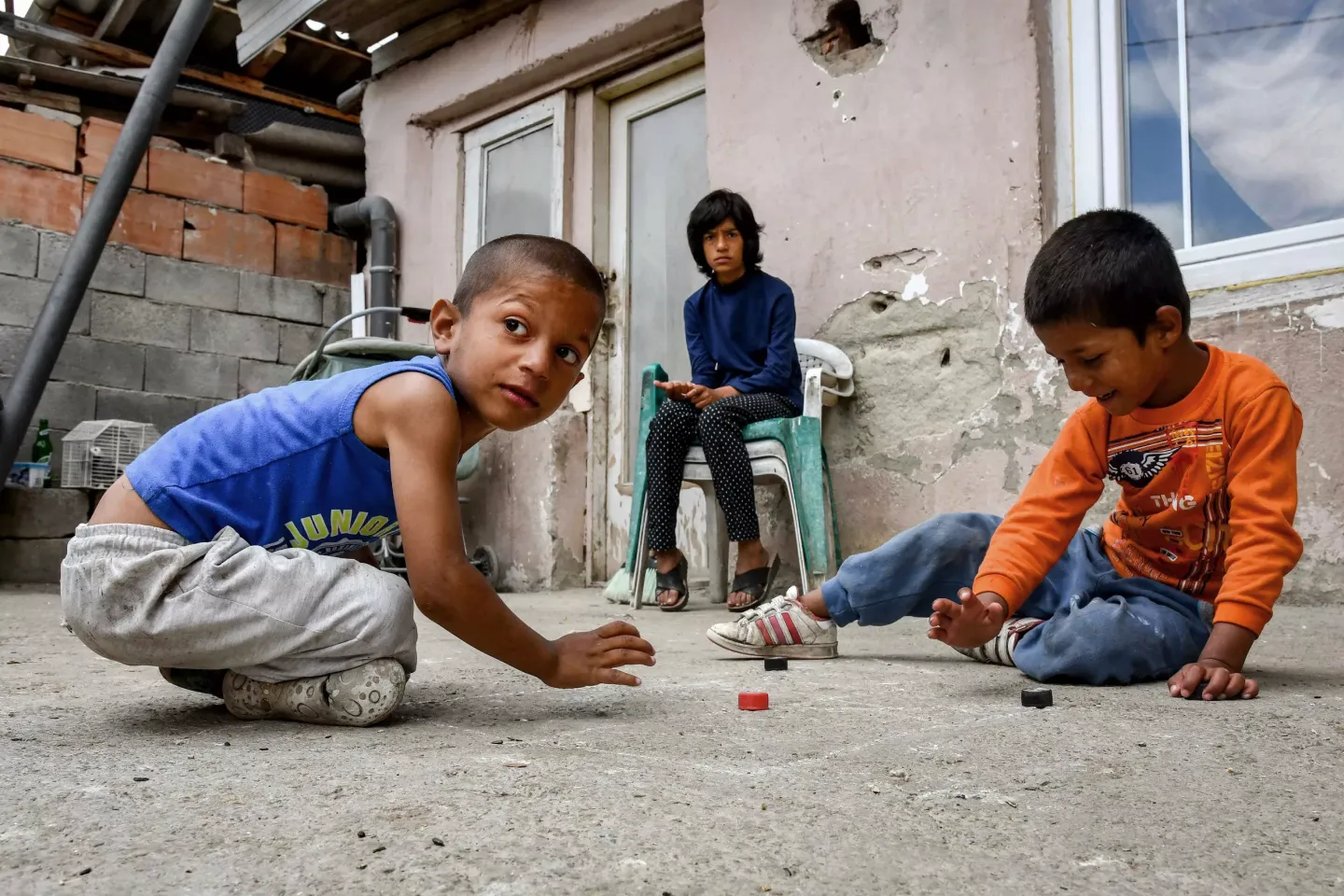 Children playing in front of a house