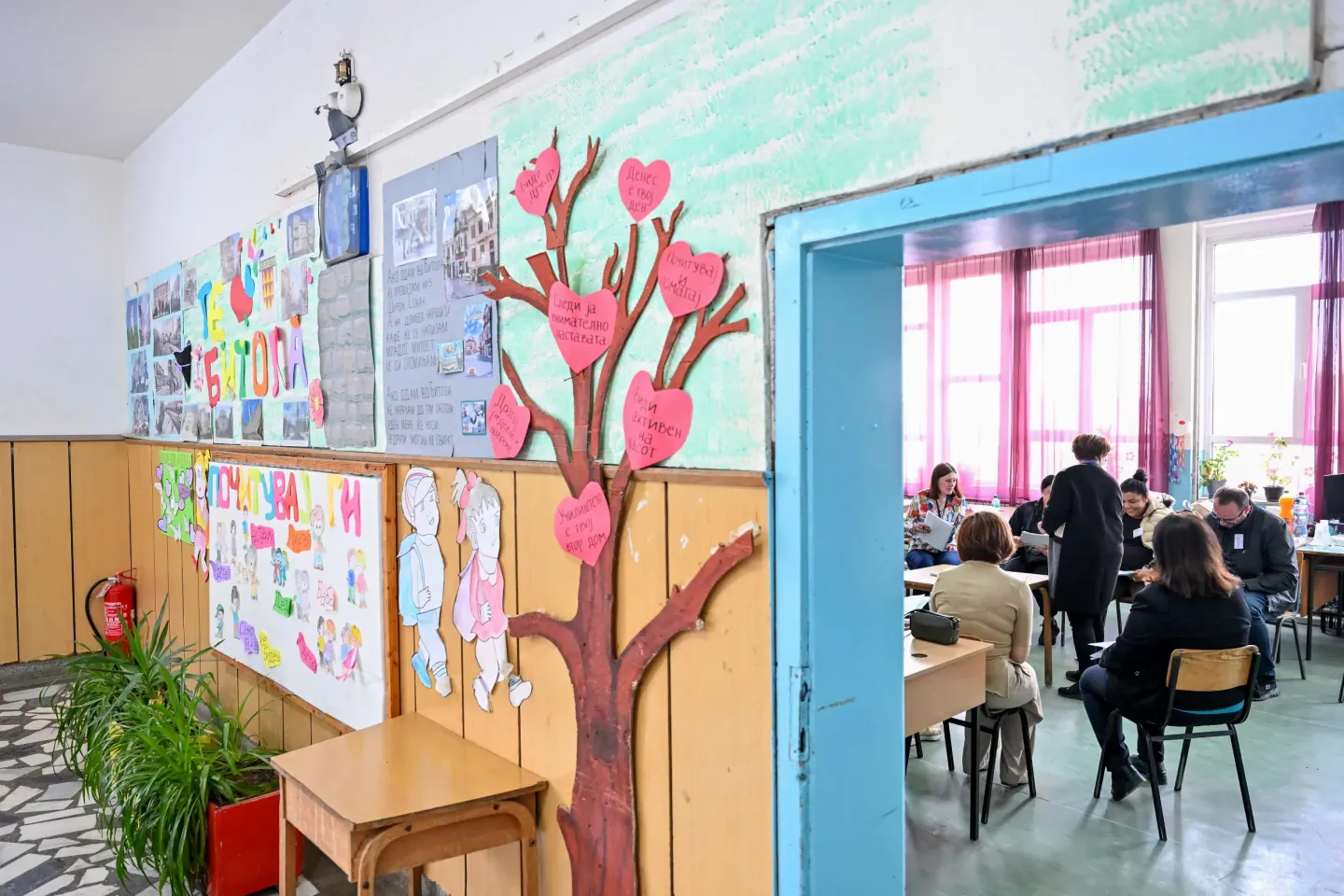 Parents siting in a school classroom. 