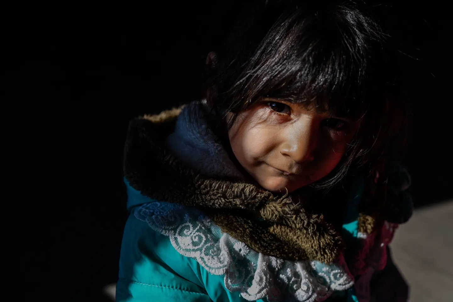 a photo of a small girl hiding in a shadow