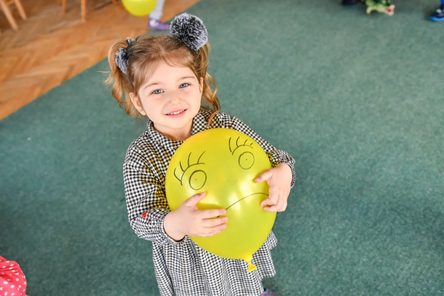 Girl holding a yellow balloon 