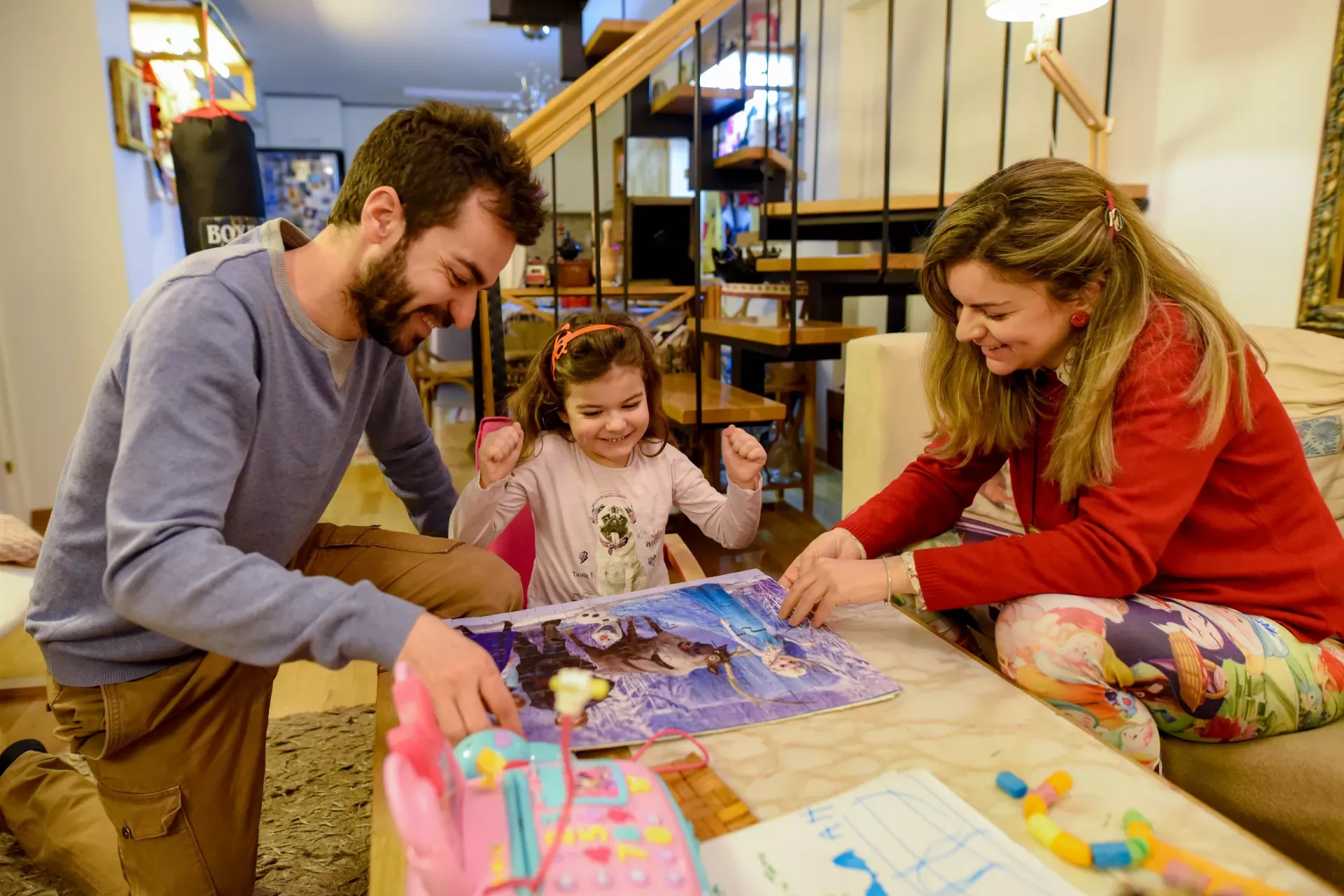 Father, mother and daughter playing board game