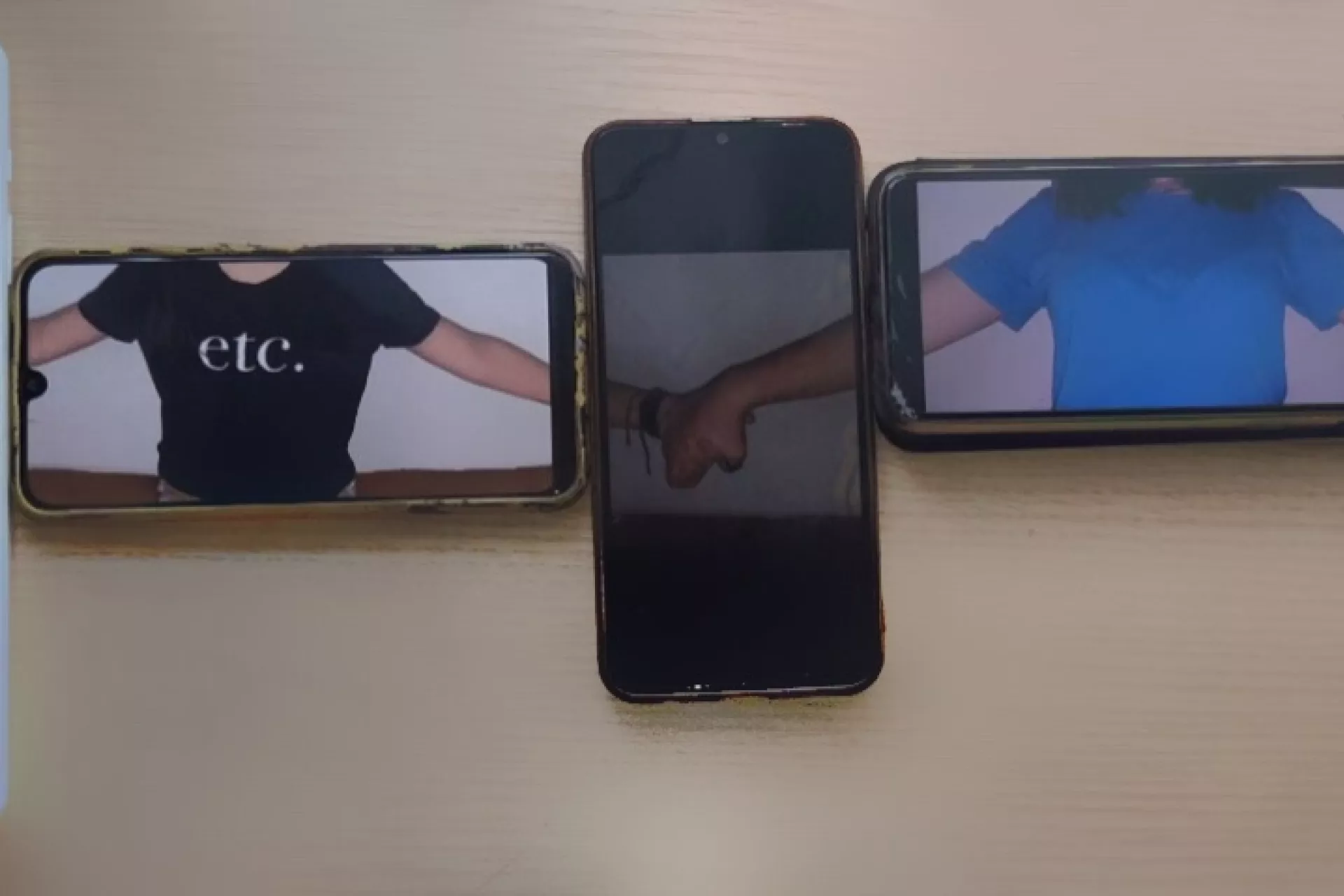 Phones lined up, on the screens we can see hands holding through the screens