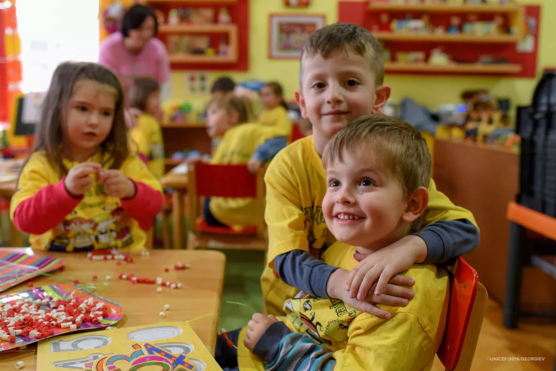 In kindergarten, Ljupco hugs his best friend Mihail who has cerebral palsy 