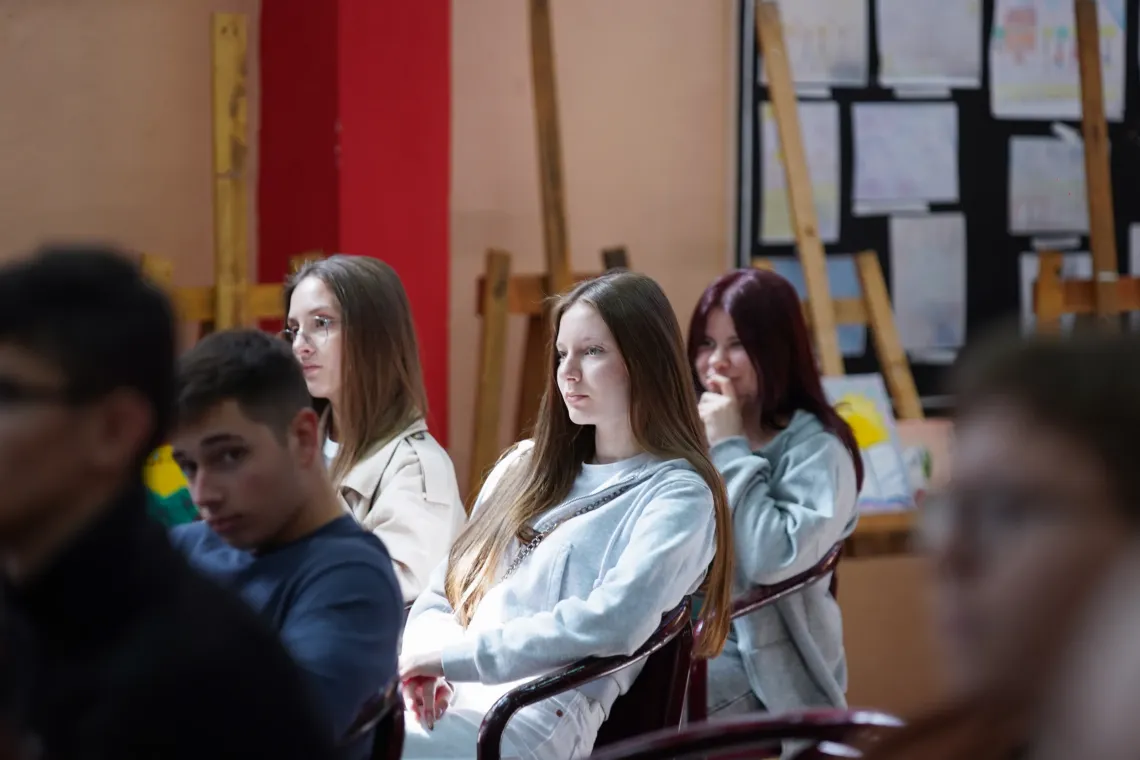 Adolescent girl in audience at a peer-to-peer workshop on the influence of marketing and food environment in schools