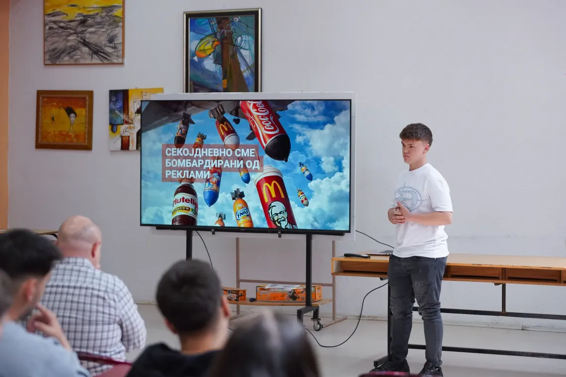 Adolescent boy presents at a peer-to-peer workshop on the influence of marketing and food environment on everyday choices 