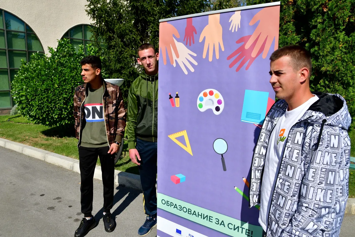 Youth Advocates for Justice for Children stand next to banner 