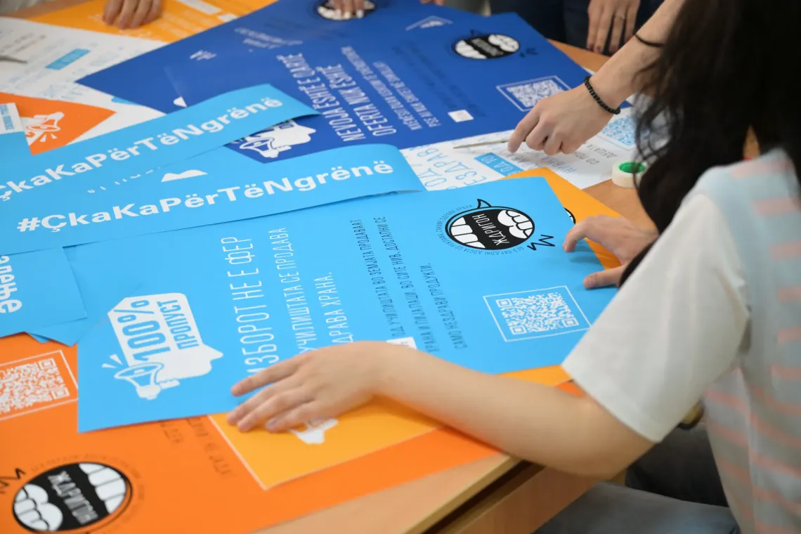 Group of adolescents looking at posters with data and messages on food environments in their school