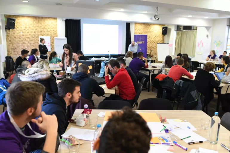 A photo from the second UPSHIFT workshop including several young teams working on air pollution problems
