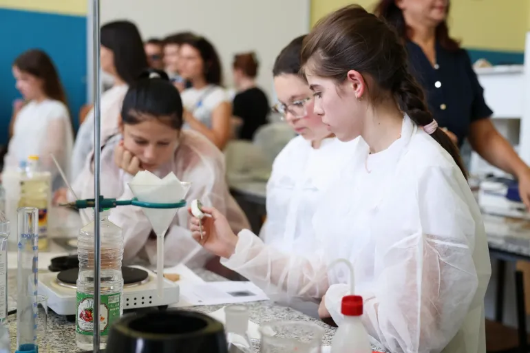A group of adolescents work in a science lab